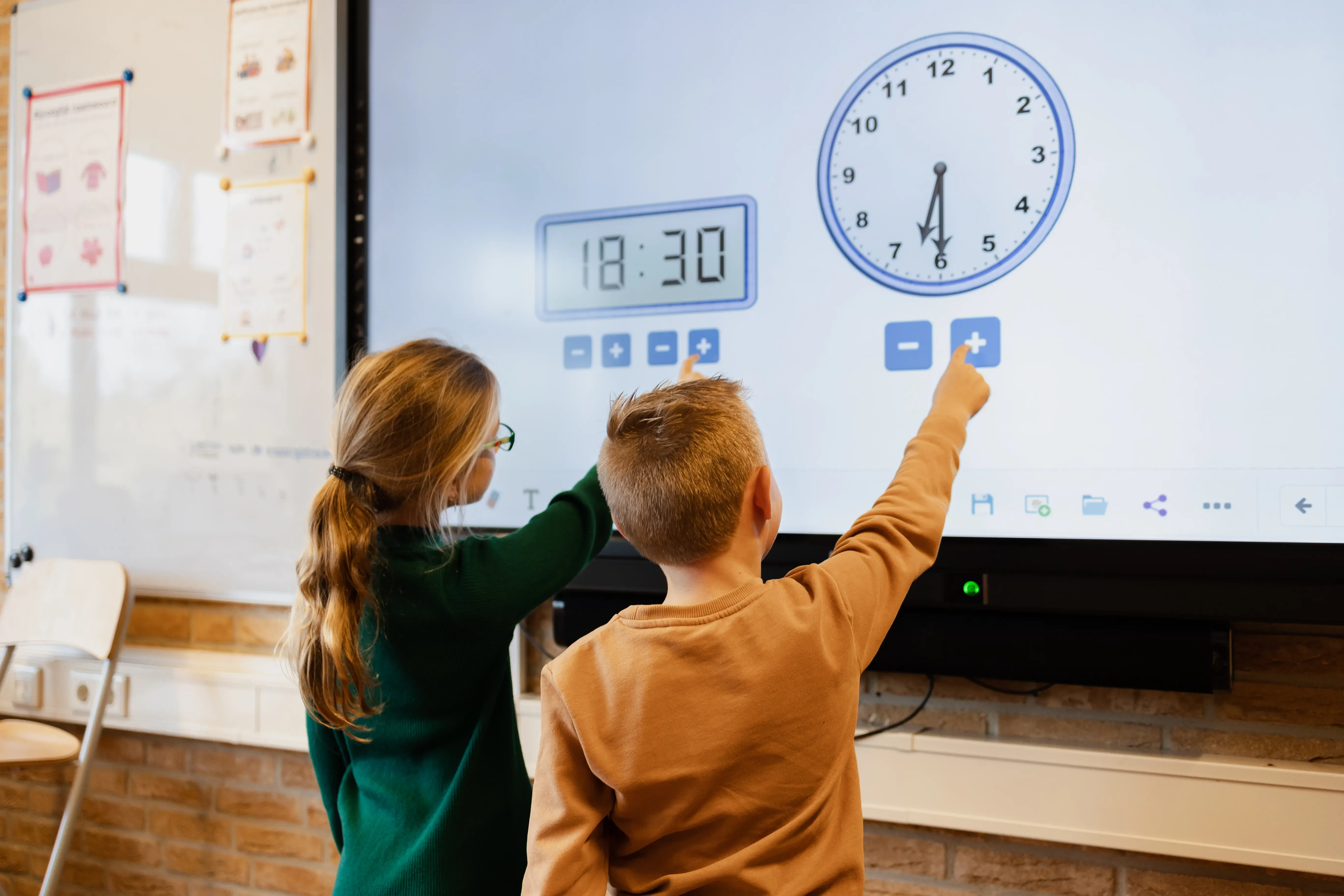 elementary school children using clocks and timers on a smartboard