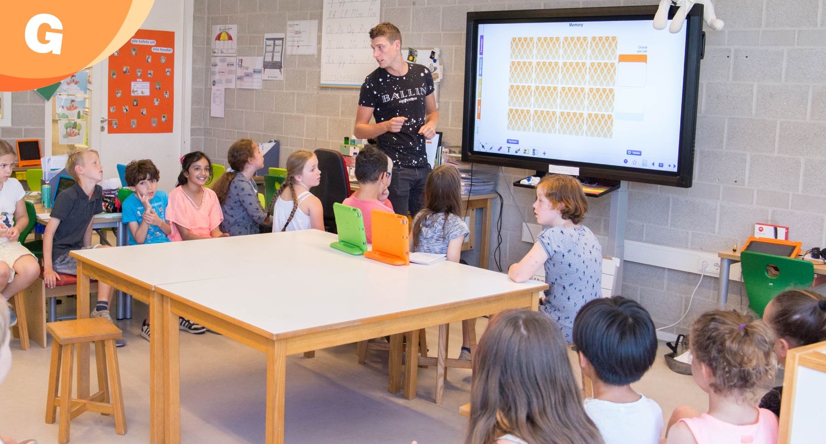 teacher explaining someting on the digital whiteboard