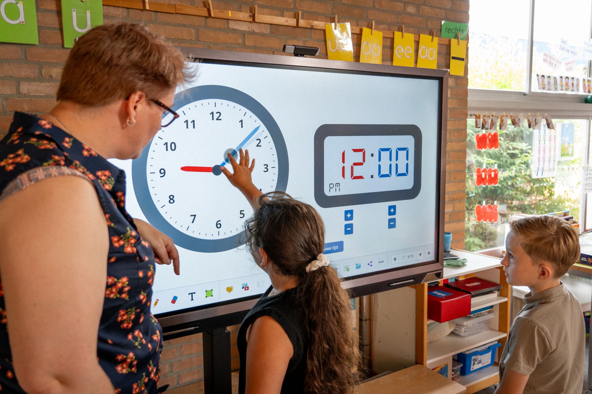 kid uses the instruction clock on a whiteboard instruction clock